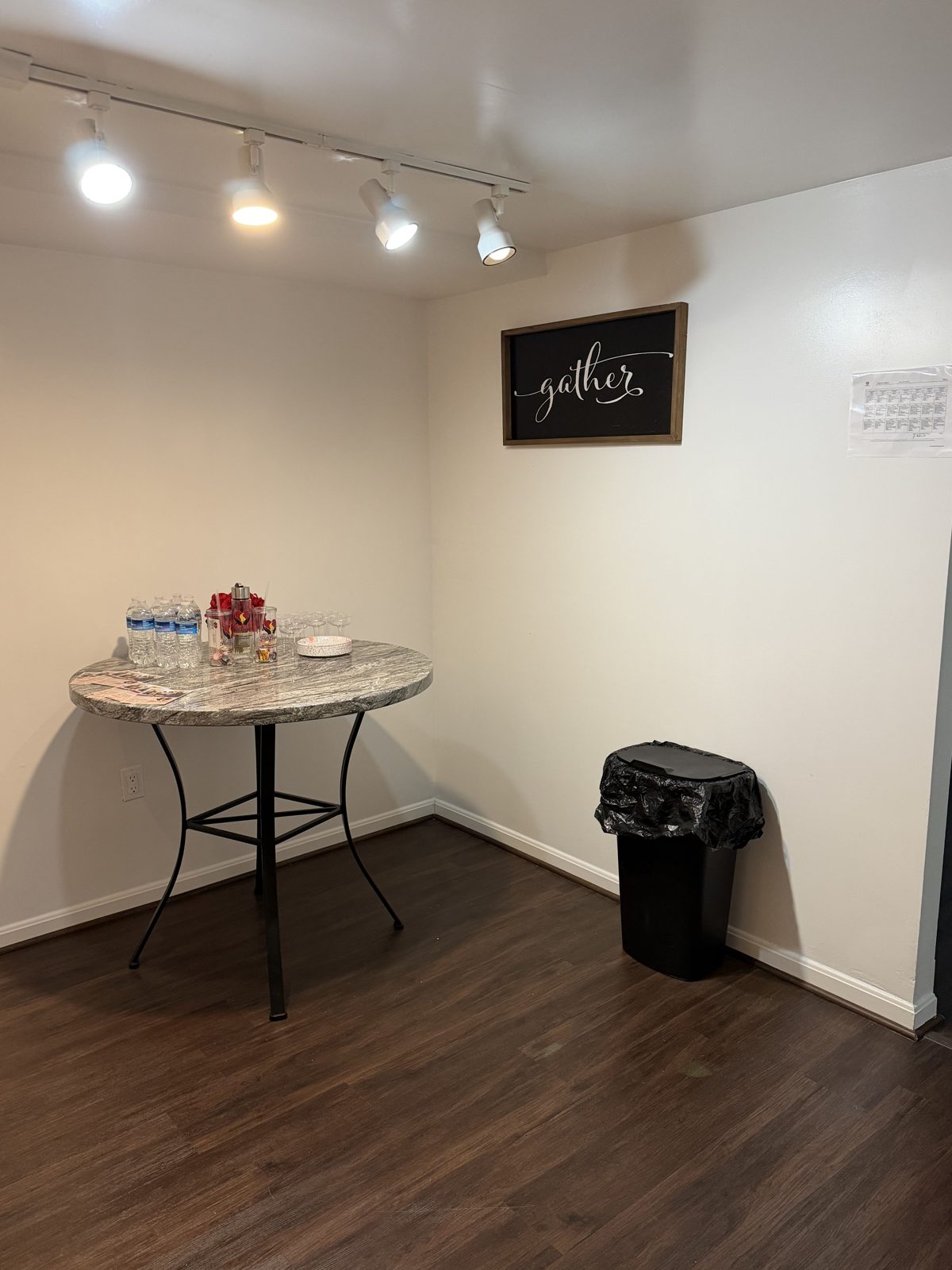 Gathering nook with a bistro table, refreshments and a sign reading gather